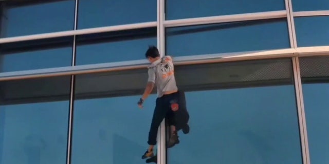 Finance student Maison Des Champs climbs the Salesforce Tower in San Francisco.