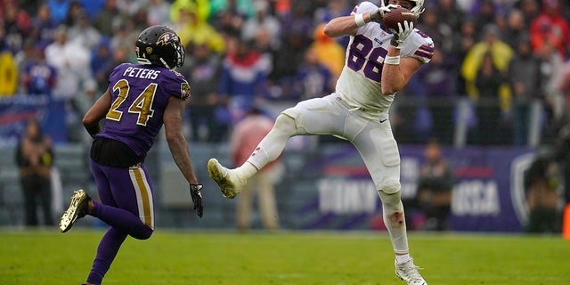 Buffalo Bills tight end Dawson Knox (88) makes a catch as he is defended by Baltimore Ravens cornerback Marcus Peters in the second half on Oct. 2, 2022, in Baltimore.