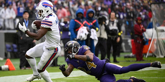 Buffalo Bills wide receiver Isaiah McKenzie, left, scores a touchdown past Baltimore Ravens cornerback Marcus Peters during the first half on Oct. 2, 2022, in Baltimore.