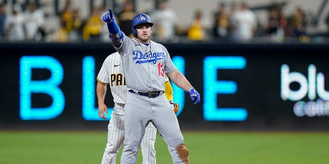 Los Angeles Dodgers' Max Muncy reacts after hitting a double during the sixth inning in Game 3 of a baseball NL Division Series against the San Diego Padres, Friday, Oct. 14, 2022, in San Diego.