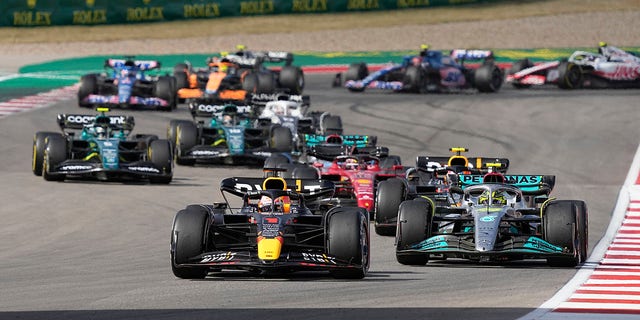 Red Bull driver Max Verstappen, front, of the Netherlands, leads Mercedes driver Lewis Hamilton, right, of Britain, and the rest of the field during the Formula One U.S. Grand Prix auto race at Circuit of the Americas, Sunday, Oct. 23, 2022, in Austin, Texas. 