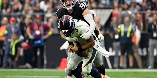Las Vegas Raiders defensive end Maxx Crosby (98) sacks Denver Broncos quarterback Russell Wilson (3) during the second half of an NFL football game, Sunday, Oct. 2, 2022, in Las Vegas.