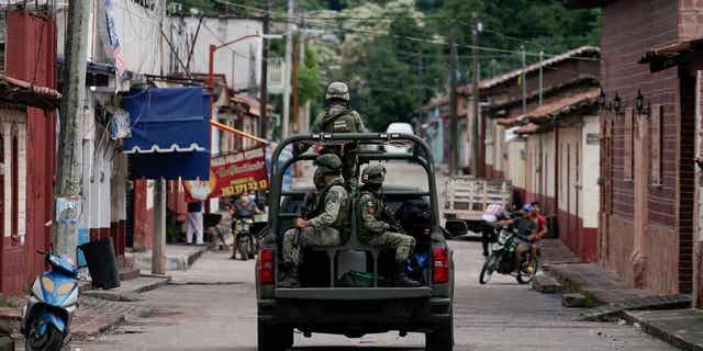 Soldiers patrol after a mass shooting that killed 20 people in San Miguel Totolapan, Mexico on October 6, 2022. Mexico passed a constitutional reform that extends the military's use for public safety until 2028. 