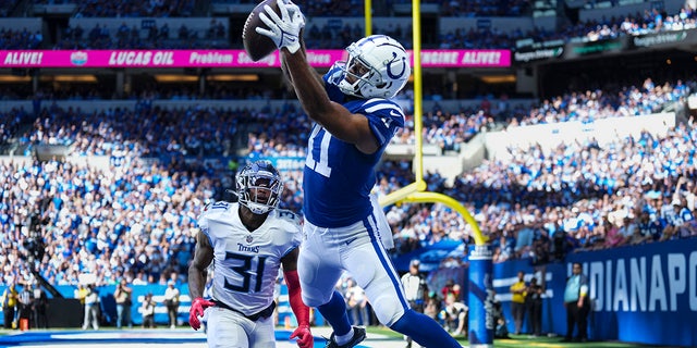 Indianapolis Colts wide receiver Michael Pittman Jr. attempts a catch in front of Tennessee Titans safety Kevin Byard in the first half of an NFL football game in Indianapolis, Fla., Sunday, Oct. 2, 2022. The pass was ruled incomplete. 