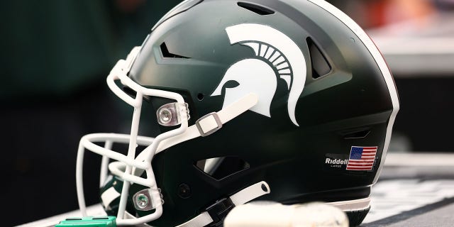 A Michigan State Spartans helmet sits on the sidelines during a game against the Rutgers Scarlet Knights at SHI Stadium on October 9, 2021, in Piscataway, NJ