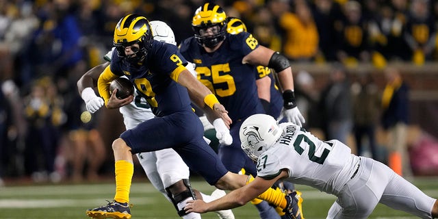 Michigan quarterback JJ McCarthy (9) runs from Michigan state linebacker Cal Haladay (27) in the first half of an NCAA college football game in Ann Arbor, Michigan on Saturday, October 18, 29, 2022.