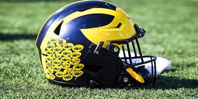 A Michigan football helmet sits on the field after a college football game between the Michigan Wolverines and the Indiana Hoosiers on October 8, 2022 at Memorial Stadium in Bloomington, Indiana.