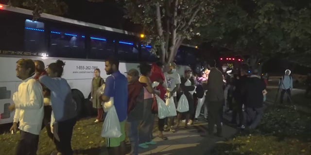 A bus carrying migrants arrived in Washington, D.C., near Vice President Kamala Harris' residence, Thursday, Oct. 6, 2022.