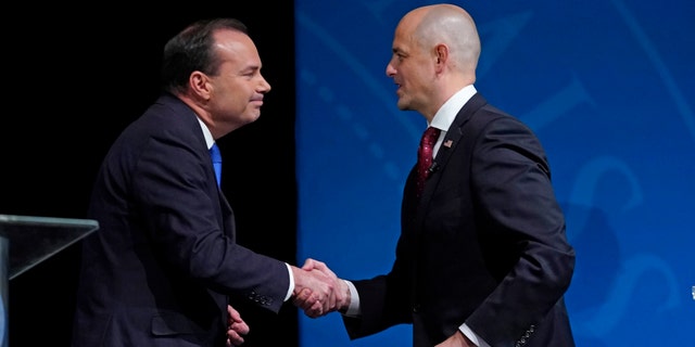 Utah Republican Sen. Mike Lee, left, and his independent challenger Evan McMullin shake hands following their televised debate, Monday, Oct. 17, 2022, in Orem, Utah, three weeks before Election Day. (AP Photo/Rick Bowmer)
