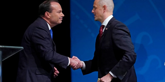 Republican Senators Mike Lee and Evan McMullin shake hands after a televised debate in Orem, Utah, Monday, October 17, 2022.