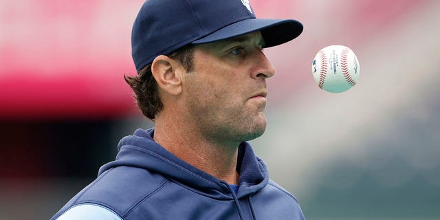 Kansas City Royals manager Mike Matheny waits for the next player to enter the cage as he pitches batting practice before the team's baseball game against the St. Louis Cardinals in Kansas City, Missouri, May 3, 2022.