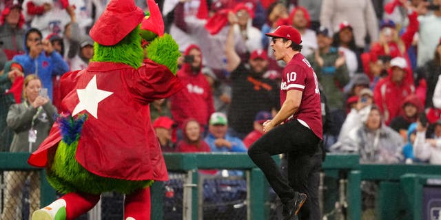 Miles Teller cheers on the field between the fifth and sixth innings during Game 5 of the NLCS between the San Diego Padres and the Philadelphia Phillies at Citizens Bank Park Sunday, Oct. 23, 2022, in Philadelphia.