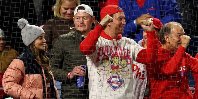 Actor Miles Teller, center, reacts during the seventh inning between the Philadelphia Phillies and the San Diego Padres in Game 4 of the National League Championship Series at Citizens Bank Park Oct. 22, 2022, in Philadelphia. 