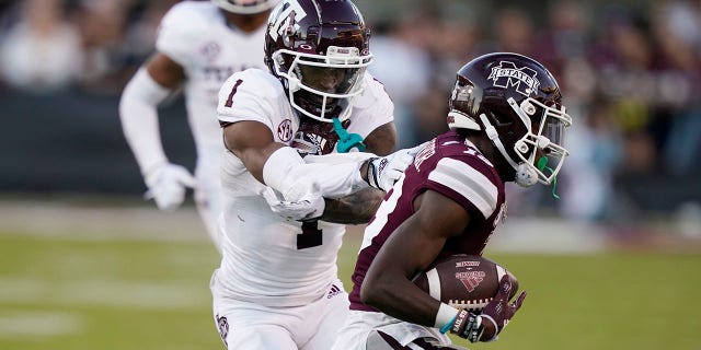 Texas A&M wide receiver Evan Stewart looses a pass as Mississippi State cornerback Emmanuel Forbes reaches in to intercept during the second half of an NCAA college football game against Mississippi State in Starkville, Miss., Saturday, Oct. 1, 2022. Mississippi State won 42-24.