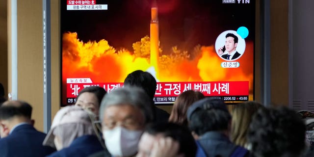 A television screen shows an image of the file of a North Korean missile launch during a news program at the train station in Seoul, South Korea, on October 14, 2022.