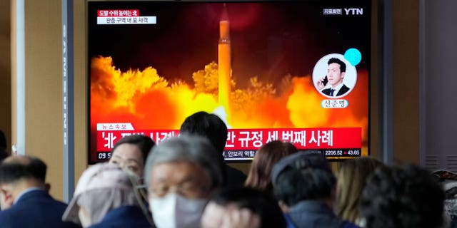 A television screen shows an image of the file of a North Korean missile launch during a news program at the train station in Seoul, South Korea, on October 14, 2022.