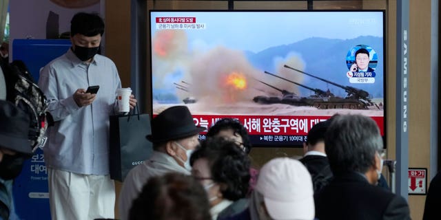 A TV screen shows a file image of North Korea's military exercise during a news program at the Seoul Railway Station in Seoul, South Korea, Friday, Oct. 14, 2022. North Korea early Friday launched a short-range ballistic missile toward its eastern waters and flew warplanes near the border with South Korea, further raising animosities triggered by the North's recent barrage of weapons tests. (AP Photo/Ahn Young-joon)