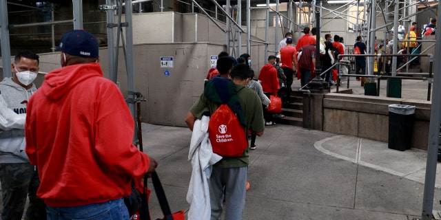 Around 60 recently arrived Venezuelan migrants are seen entering a shelter at Bellevue early Wednesday morning, Oct. 12, 2022, in Manhattan, New York. 