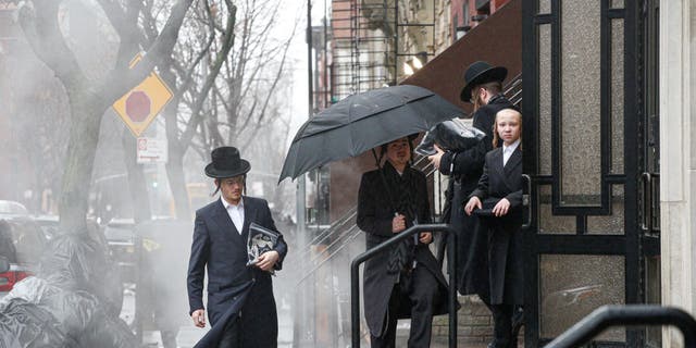 Men arrive to a Orthodox Synagogue in Brooklyn on December 30, 2019 in New York City, two days after an intruder wounded five people at a rabbi's house in Monsey, New York during a gathering to celebrate the Jewish festival of Hanukkah. 