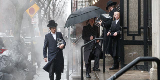 Men arrive to a Orthodox Synagogue in Brooklyn on December 30, 2019 in New York City, two days after an intruder wounded five people at a rabbi's house in Monsey, New York during a gathering to celebrate the Jewish festival of Hanukkah. 