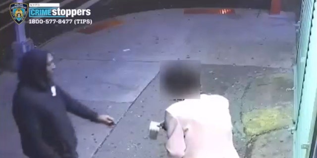 The woman reaches out toward the suspect