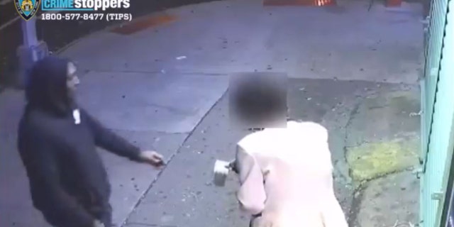 The woman reaches out toward the suspect