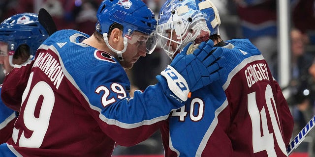 Avalanche raise Stanley Cup banner, start title defense with win 2 Colorado Avalanche center Nathan McKinnon congratulates goaltender Alexandar George following the team's 5-2 win over the Chicago Blackhawks, Wednesday, Oct. 12, 2022, in Denver.