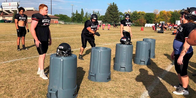 Defensive lineman Ray Ruschel, gesturing at center, is a 49-year-old college freshman at North Dakota State College of Science. Here, he works on rushing techniques during practice Sept. 20, 2022, in Wahpeton, N.D.