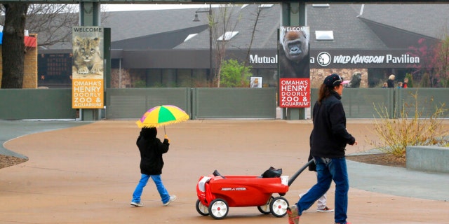 FILE - Visitors walk to the entrance of the Henry Doorly Zoo in Omaha, Neb., on April 7, 2015. The zoo has closed several exhibits and taken other precautions after one of its pelicans died from the bird flu on Thursday, Oct. 13, 2022. 