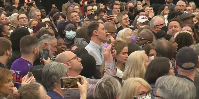 The man in the collared shirt and short hair was seen yelling at former President Barack Obama during a rally in Michigan on Saturday. The man later left the rally.