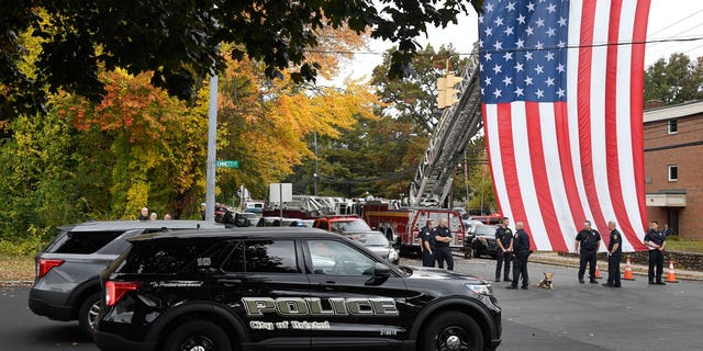 FILE - Police officers from Bristol, Conn. gather with other towns at the scene where two police officers killed, Thursday, Oct. 13, 2022, in Bristol, Conn. The deaths of two Connecticut police officers and the wounding of a third during an especially violent week for police across the U.S. fit into a grim pattern, law enforcement experts say. Even as the number of officers has dropped in the past two years, the number being targeted and killed has risen. (AP Photo/Jessica Hill, File)