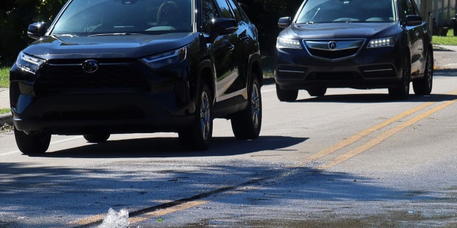 Water gushed Sunday morning, Oct. 2, 2022, from a sewage manhole cover along Winter Park's Lakemont Avenue just west of Winter Park High School, in Florida. 