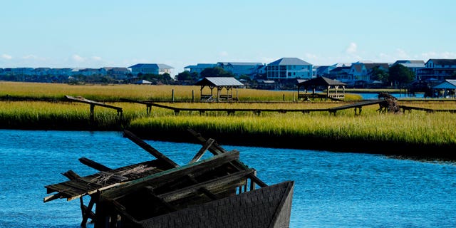 A boat house is overturned in the inlet between Pawleys Island and the mainland following winds and rain from Hurricane Ian on Saturday, Oct. 1, 2022, in Pawleys Island, S.C. 