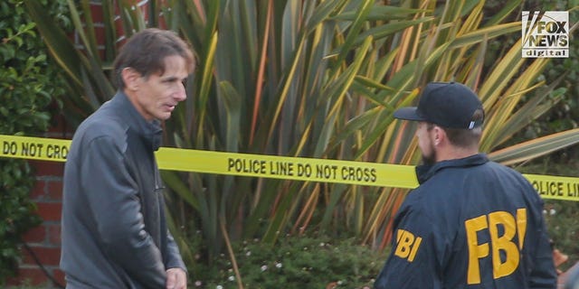 Paul Pelosi Jr. speaks to FBI investigators outside the home of his parents Nancy and Paul Pelosi, Friday Oct. 28, 2022. His father, Paul was the victim of a violent home invasion earlier this morning.