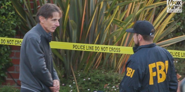 Paul Pelosi Jr. speaks to FBI investigators outside the home of his parents Nancy and Paul Pelosi, Friday October 28, 2022. His father, Paul was the victim of a violent home invasion earlier this morning.