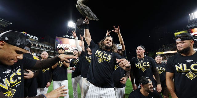 Jorge Alfaro of the San Diego Padres celebrates with a plastic goose after defeating the Los Angeles Dodgers 5-3 in Game 4 of a National League Division Series at Petco Park Oct. 15, 2022, in San Diego, Calif.