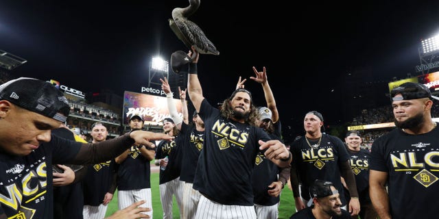 Jorge Alfaro of the San Diego Padres celebrates with a plastic goose after defeating the Los Angeles Dodgers 5-3 in Game 4 of a National League Division Series at Petco Park Oct. 15, 2022, in San Diego, Calif.