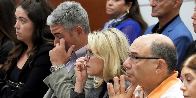 FILE – From left; Abby Hoyer, Tom and Gena Hoyer, and Michael Schulman react during the reading of jury instructions in the penalty phase of the trial of Marjory Stoneman Douglas High School shooter Nikolas Cruz at the Broward County Courthouse in Fort Lauderdale, Fla. on Wednesday, Oct. 12, 2022. The Hoyer's son, Luke, and Schulman's son, Scott Beigel, were killed in the 2018 shootings. Abby Hoyer is Luke Hoyer's sister. Cruz previously plead guilty to all 17 counts of premeditated murder and 17 counts of attempted murder in the 2018 shootings.