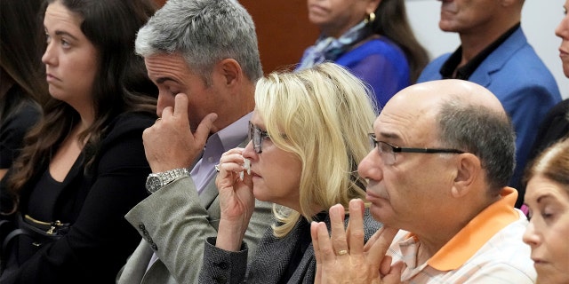 From left; Abby Hoyer, Tom and Gena Hoyer, and Michael Schulman react during the reading of jury instructions in the penalty phase of the trial of Marjory Stoneman Douglas High School shooter Nikolas Cruz at the Broward County Courthouse in Fort Lauderdale, Fla. on Wednesday, Oct. 12, 2022. The Hoyer's son, Luke, and Schulman's son, Scott Beigel, were killed in the 2018 shootings. Abby Hoyer is Luke Hoyer's sister. Cruz previously plead guilty to all 17 counts of premeditated murder and 17 counts of attempted murder in the 2018 shootings.