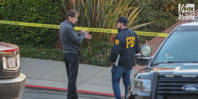 Paul Pelosi Jr. speaks to FBI investigators outside the home of his parents Nancy and Paul Pelosi, Friday, Oct. 28, 2022. His father, Paul, was the victim of a violent home invasion earlier this morning.