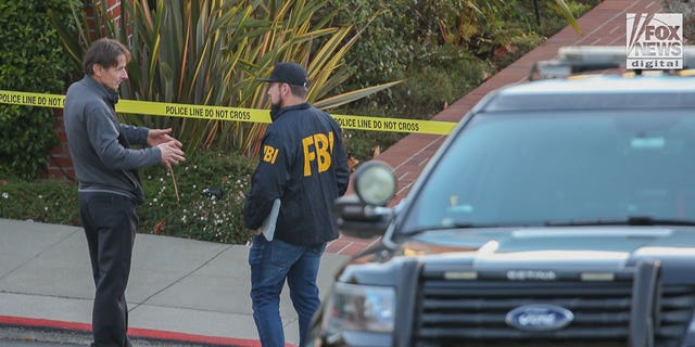 Paul Pelosi Jr.  speaks with FBI investigators outside the home of his parents, Nancy and Paul Pelosi, Friday, Oct. 28, 2022. His father was the victim of a violent burglary earlier that morning.