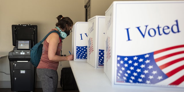 A voter casts a ballot at a polling location in Pittsburgh May 17, 2022. 