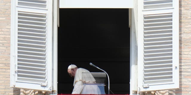 Pope Francis leaves after the midday Angelus prayer from the window of his studio overlooking St. Peter's Square in the Vatican on Sunday, October 2, 2022. 