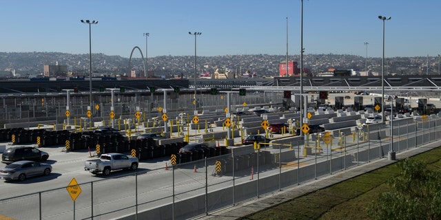 Vehicles enter a border checkpoint as they approach the Mexico border at the US Customs and Border Protection (CBP) San Ysidro Port of Entry at the US Mexico border on February 19, 2021, in San Diego, California. 