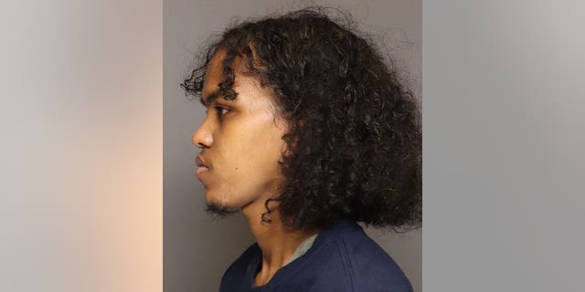 Qadar Mohamed Aden seen in booking photo after more than 100 fentanyl-laced pills were found on his person.