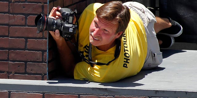 Former MLB pitcher Randy Johnson photographs the women's skateboard street competition during X Games 18 in Los Angeles, June 29, 2012.