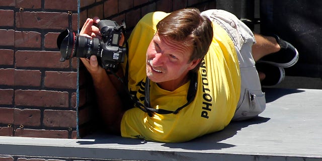 Former MLB pitcher Randy Johnson photographs the women's skateboard street competition during X Games 18 in Los Angeles, June 29, 2012.