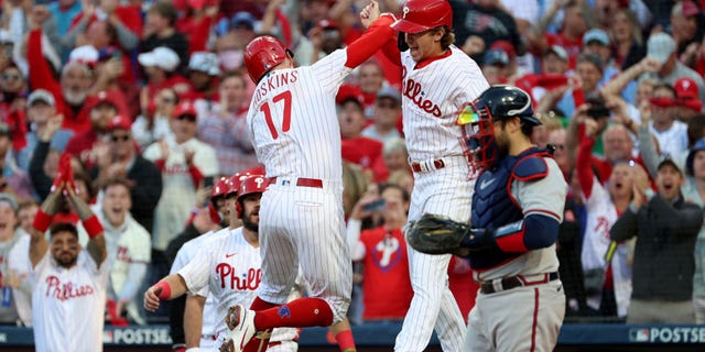 Rhys Hoskins (17) of the Philadelphia Phillies celebrates with Bryson Stott (5) after hitting a two-run home run against Spencer Strider of the Atlanta Braves during the third inning in Game 3 of the National League Division Series at Citizens Bank Park Oct. 14, 2022, in Philadelphia.
