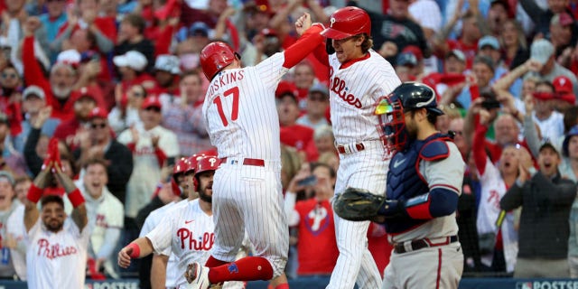 Rhys Hoskins (17) of the Philadelphia Phillies celebrates with Bryson Stott (5) after hitting a two-run home run against Spencer Strider of the Atlanta Braves during the third inning in Game 3 of the National League Division Series at Citizens Bank Park Oct. 14, 2022, in Philadelphia.