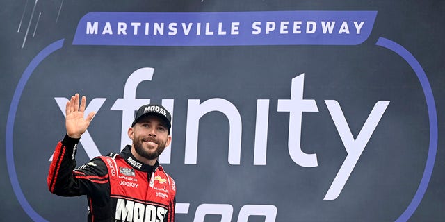 Ross Chastain waves to fans as he walks onstage during driver intros prior to the Xfinity 500 at Martinsville Speedway on Oct. 30, 2022, in Martinsville, Virginia.